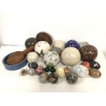 A mixed lot including a collection of glass, ceramic and stone boules, and a similar collection of