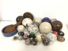 A mixed lot including a collection of glass, ceramic and stone boules, and a similar collection of