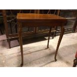 An Edwardian mahogany card table, the rectangular top with boxwood and ebony strung border,