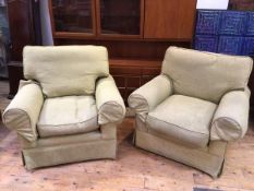 A pair of John Lewis armchairs in green linen upholstery, with rolled arms, on circular feet (