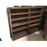 A late 19thc/early 20thc mahogany open bookcase, the moulded top above a central vertical fluted