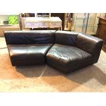 A Rolf Benz corner sofa in two sections, in black leather upholstery (67cm x 250cm x 130cm)