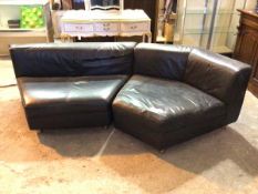 A Rolf Benz corner sofa in two sections, in black leather upholstery (67cm x 250cm x 130cm)