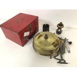 A 1940s/50s portable Primus stove, complete with red travelling case (12cm x 19.5cm x 17cm)