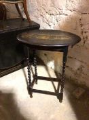 A 1930s/40s ebonised occasional table, the oval top with moulded edge on barley twist supports