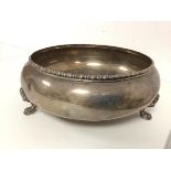 A footed bowl with beaded edge and lion paw feet, marked sterling silver to base (8cm x 22cm) (