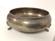 A footed bowl with beaded edge and lion paw feet, marked sterling silver to base (8cm x 22cm) (