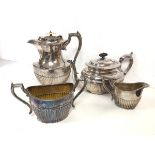 An Epns set of coffee or hot water jug, milk jug and sugar bowl, with gadrooned base (jug: 21cm) and