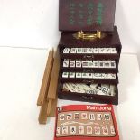 A boxed mah-jong set, travelling case with sliding top and five drawers to interior, complete with
