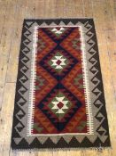 A Maimana kelim rug, with diamonds within a tan and brown running dog border (129cm x 80cm)