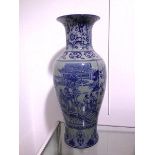 A Chinese baluster vase with flared rim and blue decorated body, two panels depicting a Gift