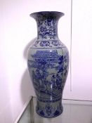 A Chinese baluster vase with flared rim and blue decorated body, two panels depicting a Gift