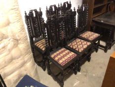 A set of six ebonised reproduction 1920s/30s Tudor style side chairs with scrolling leaf and vine