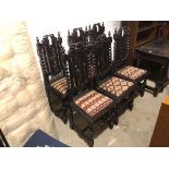 A set of six ebonised reproduction 1920s/30s Tudor style side chairs with scrolling leaf and vine