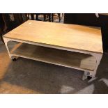 An industrial style coffee table, the rectangular top above an undertier, on white painted metal