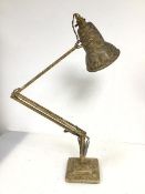 A mid 20thc anglepoise table lamp with mottled gilt finish, the shade with rolled edge to bottom, on