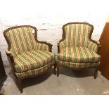 A pair of Louis XVI style bergeres with green and floral striped upholstery, on cabriole supports (