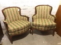 A pair of Louis XVI style bergeres with green and floral striped upholstery, on cabriole supports (