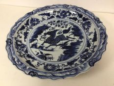 A mid 20thc or later Chinese blue and white charger with scalloped rim and mythical horse to well (