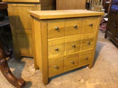 A Next Furniture oak chest of drawers, the rectangular top above three drawers each with three