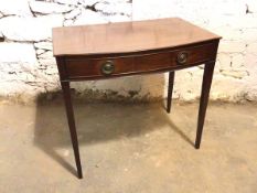 A Georgian style bow front mahogany writing table fitted frieze drawer on square tapering