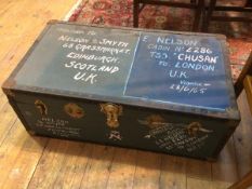 A vintage travelling trunk with inscriptions to exterior and quantity of textiles to interior