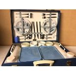 A Brexton picnic case, complete with four small plates, four bowls, forks, knives, spoons, mugs,