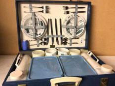 A Brexton picnic case, complete with four small plates, four bowls, forks, knives, spoons, mugs,