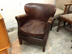 A John Lewis studded brown leather low chair, with scroll arms with seat cushion, on straight square