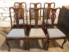 A set of four Queen Anne style mahogany dining chairs with dished top rails over baluster splats, on