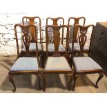 A set of four Queen Anne style mahogany dining chairs with dished top rails over baluster splats, on