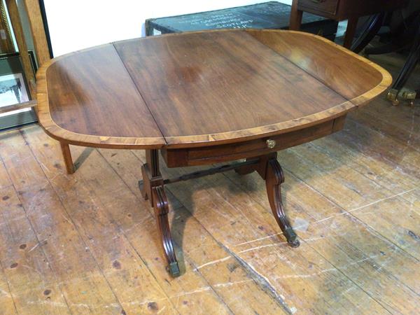 A Georgian inspired drop leaf mahogany occasional table, with walnut crossbanding, the table of