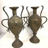 A pair of metal vases of baluster form with cobra handles to sides and engraved with foliate and