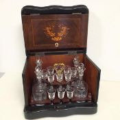 A mid 20thc. travelling drinks cabinet, with four decanters and eleven liqueur glasses (27cm x