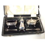 A Sheffield silver condiment set with pepperette, salt and mustard pot, with two spoons (combined: