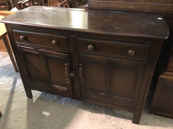 A 1930s/40s dresser base, with two frieze drawers above a single recess with shelf enclosed within