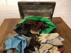 An assortment of gloves and leather offcuts in vintage box with brass handles and inscribed N to