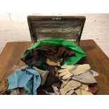 An assortment of gloves and leather offcuts in vintage box with brass handles and inscribed N to