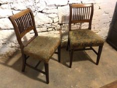 A pair of Regency mahogany chairs, with upholstered seats and reeded front supports united by H