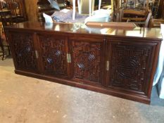 A Chinese cherrywood sideboard, the top comprised of four cabinet doors with an arrangement of