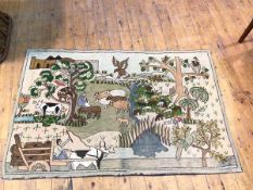 A pictoral rug or wallhanging depicting a shepherd with his flock, man on wagon and other animals,