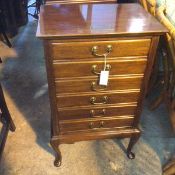 A Georgian style mahogany music cabinet, the top with brass plaque inscribed Presented to Mr James