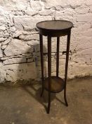 A 1920s oak plant stand, with circular top and lower tier on outswept feet (95cm x 31cm)