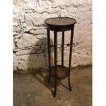 A 1920s oak plant stand, with circular top and lower tier on outswept feet (95cm x 31cm)