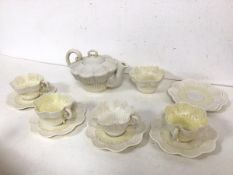 An Edwardian Irish Belleek part teaset, with teapot (11cm x 20cm x 14cm), four teacups, six