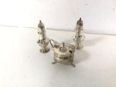 A pair of Birmingham silver pepperettes and condiment pot with glass insert (combined: 87.05g)