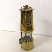 A miners safety lamp by Protector Lamp and Lighting Company Ltd., inscribed Eccles, Manchester (