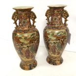 A pair of mid 20thc Chinese vases, of baluster form with handles to flared neck, with panels