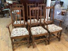 A set of six Ercol elm dining chairs with architectural top rail on spindle back with upholstered