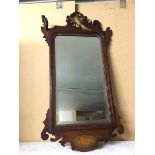 An Edwardian wall mirror, the bevelled mirror within a carved frame, with ho ho bird surmount and